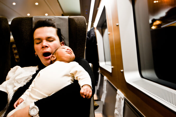 Tired Woman And Child Relaxing In Luxury High Speed Train At Night