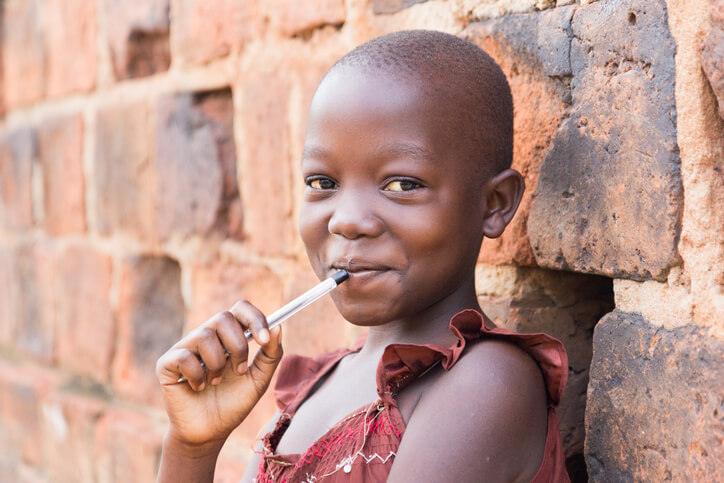 an African girl smiling at the camera