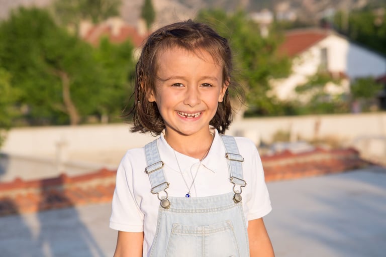 a Turkish girl smiling while outdoors