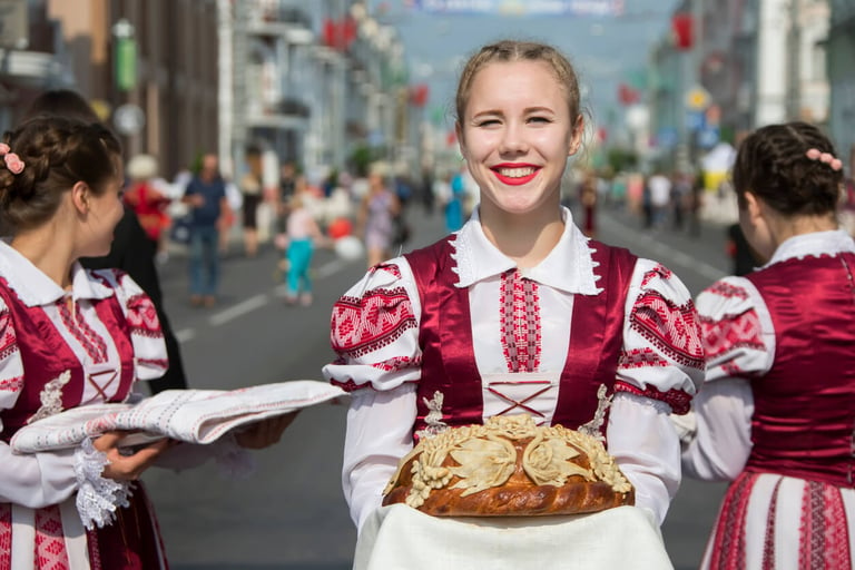 Belarusian woman in national Slavic costume with bread and salt