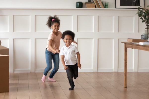 Excited preschooler kids have fun running at home