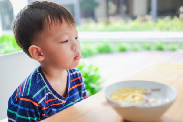 Asian 3 - 4 years old toddler boy child wearing striped t shirt refuse to eat food