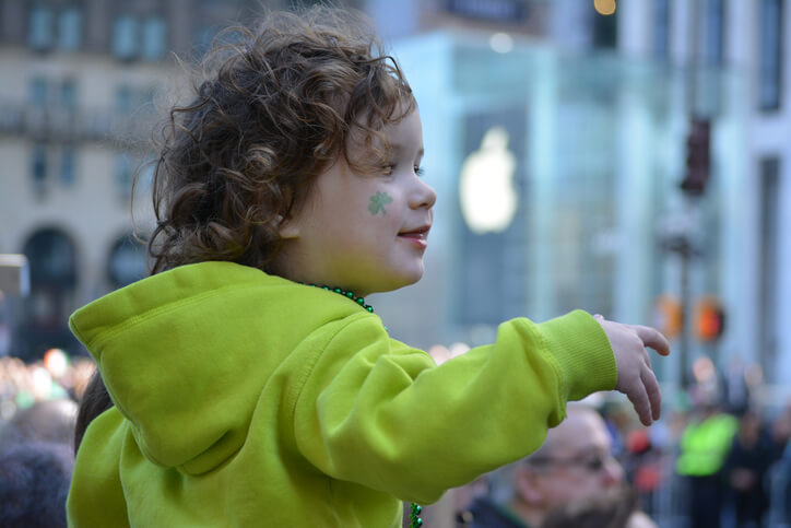 New York City, USA - March 16, 2016: Young girl watching the St. Patrick's Day Parade in Midtown Manhattan in 2016.