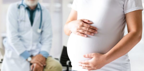Pregnant Woman and Doctor at Hospital
