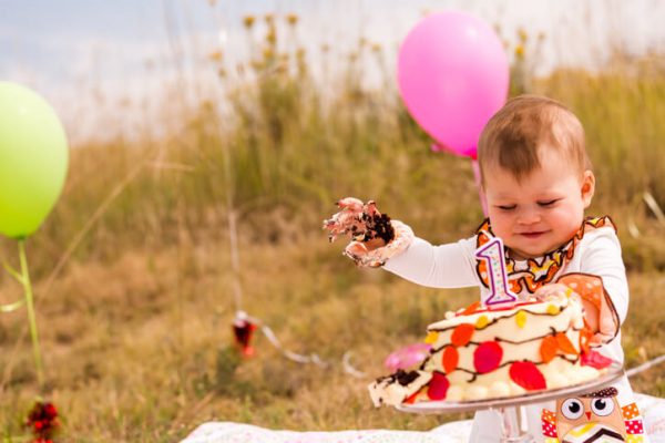 a baby smashing his cake on his first birthday