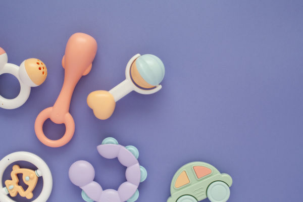 Flat lay composition with baby rattles set in pastel colors