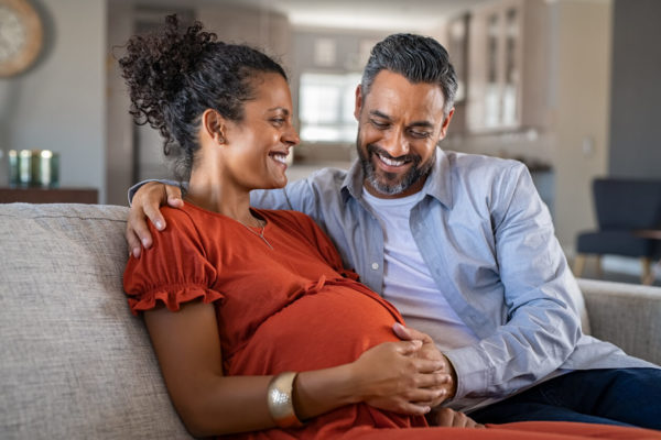 Happy mixed race couple expecting baby