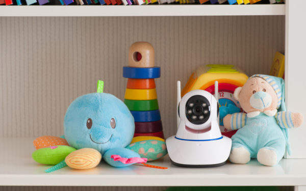 IP camera on the shelf with toys, serving as a baby monitor