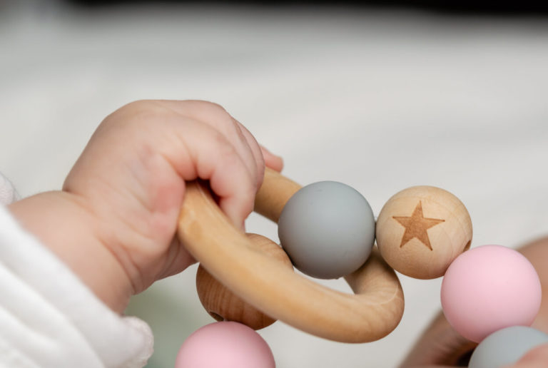 Close-up of a babyÂ´s hand, playing with a wooden toy
