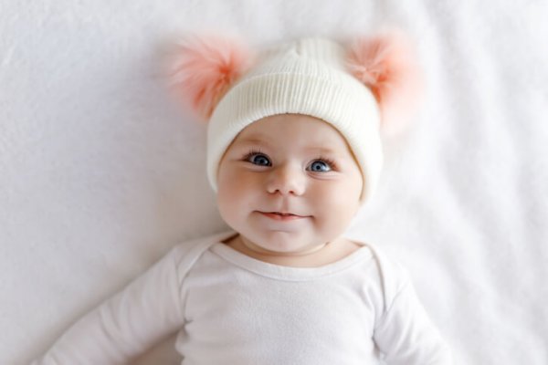 a cute baby girl with a cute hat