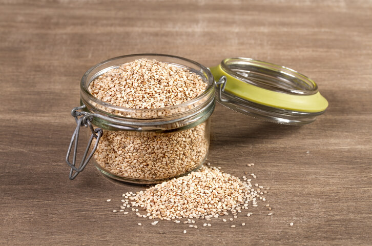Sesame grains in large wooden spoon, grain and wheat is helpful to increase breast milk supply