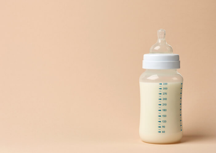 a baby bottle filled with breast milk