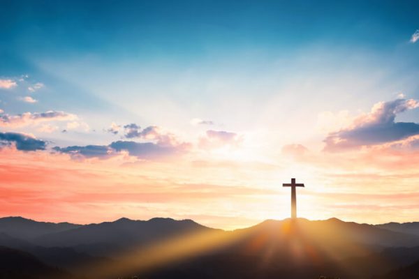 biblical cross on mountain sunset background