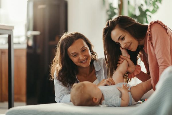 Affectionate women enjoying in time with a baby son at home