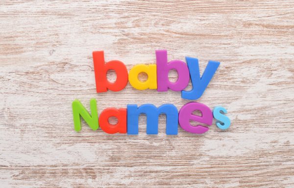 baby names spelt out on a wooden table