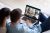 Young couple talk on video call with diverse friends