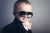 Young boy dressed as a gentleman with sunglasses