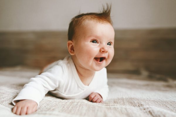 Smiling baby infant crawling at home