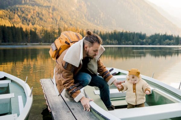 a dad and his baby on a boat during October