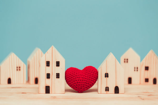 Love heart between two house wood model for stay at home for healthy community together concept