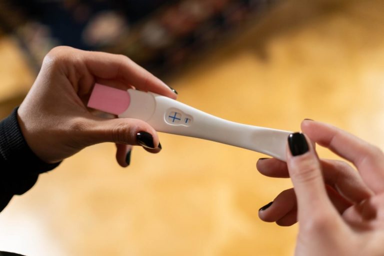 a woman taking a pregnancy test