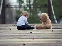 Boy Sitting With Brown Bear Plush Toy