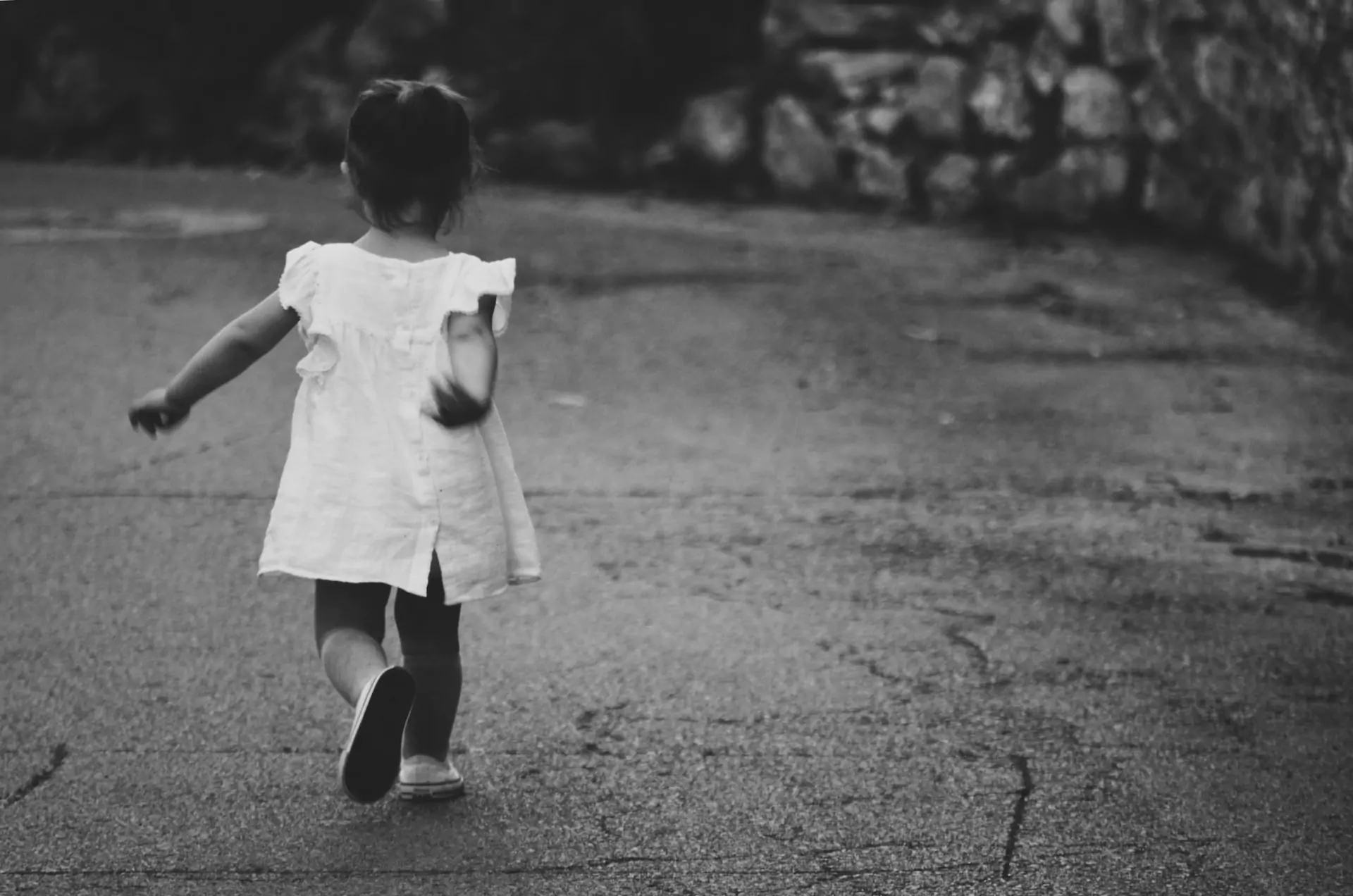 a vintage photo of a young girl walking outside