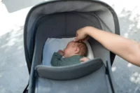 Cute Baby Sleeping in Gray Stroller