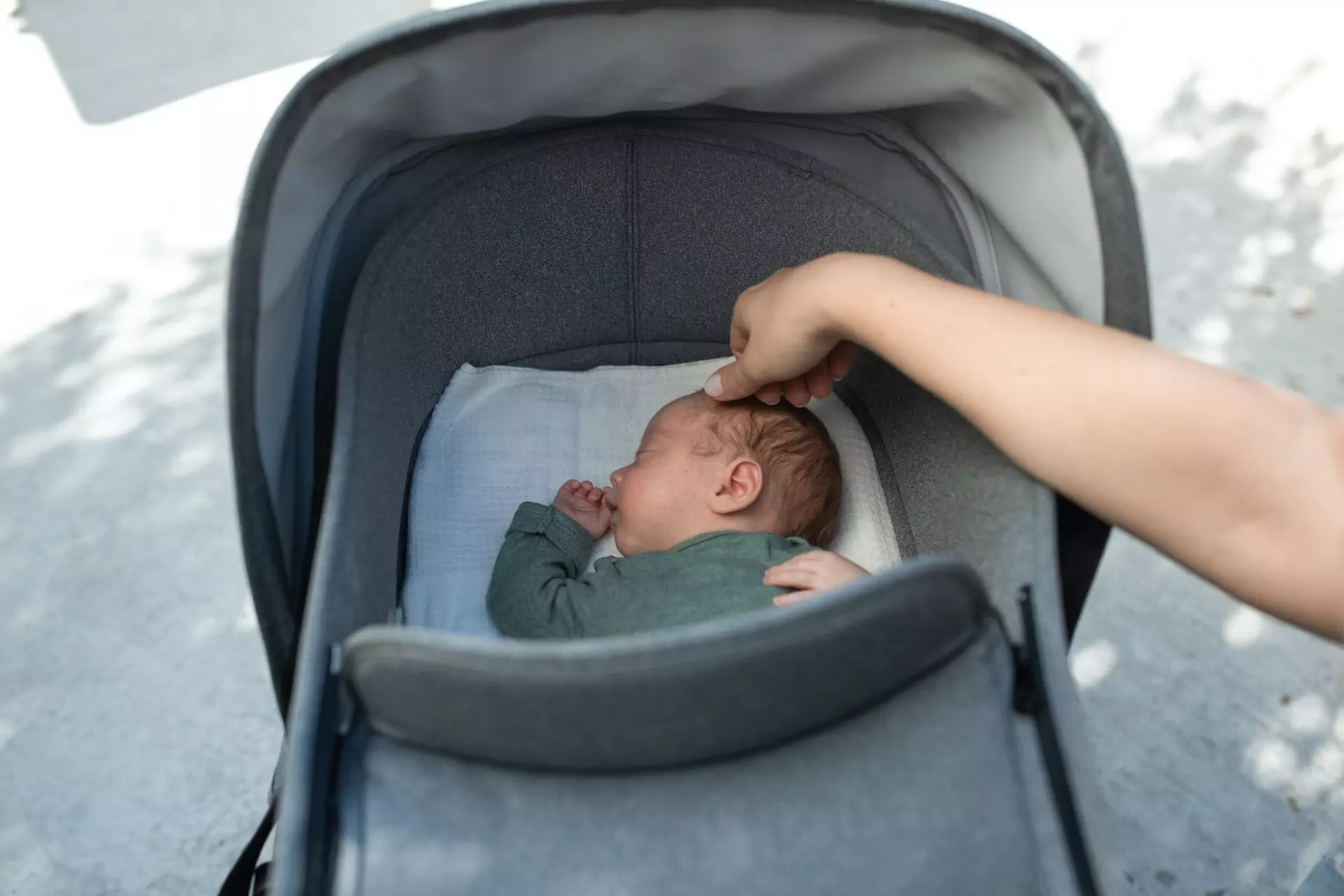Cute Baby Sleeping in Gray Stroller